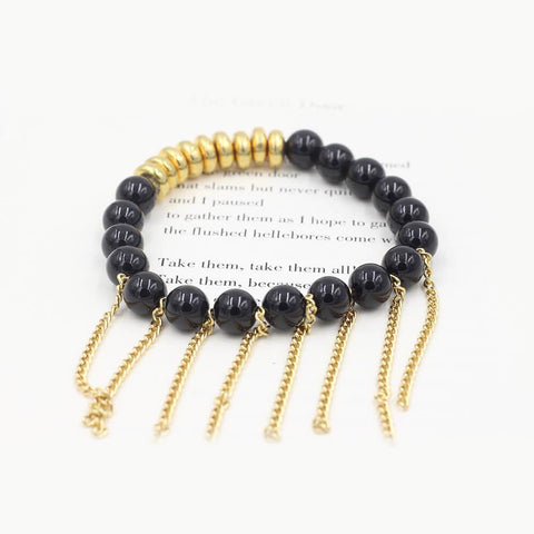 Susan Balaban Designed Healing Bracelet - This black healing yoga bracelet is made of tourmaline and gold fringe for strength and grounding.